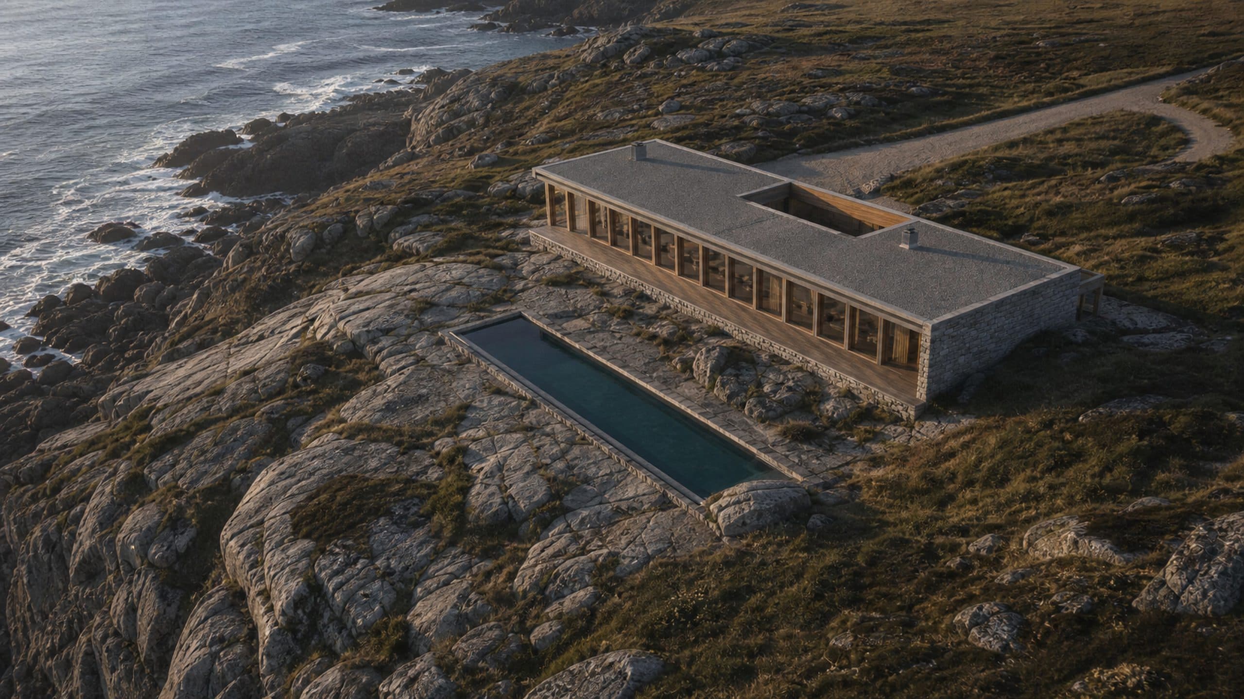 An aerial view of Vellan House on its granite shelf, the lap pool and courtyard visible beside it.